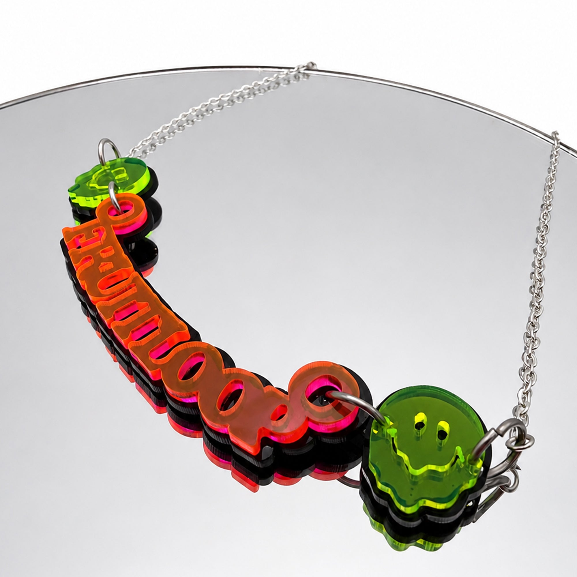Fruitloop Neon Orange and Black Acrylic Necklace on mirror background