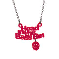A red acrylic pendant necklace spelling out 'Head in the Bass Bin' with a small matching red smiley face charm hanging below, suspended from a silver-tone chain against a plain white background.