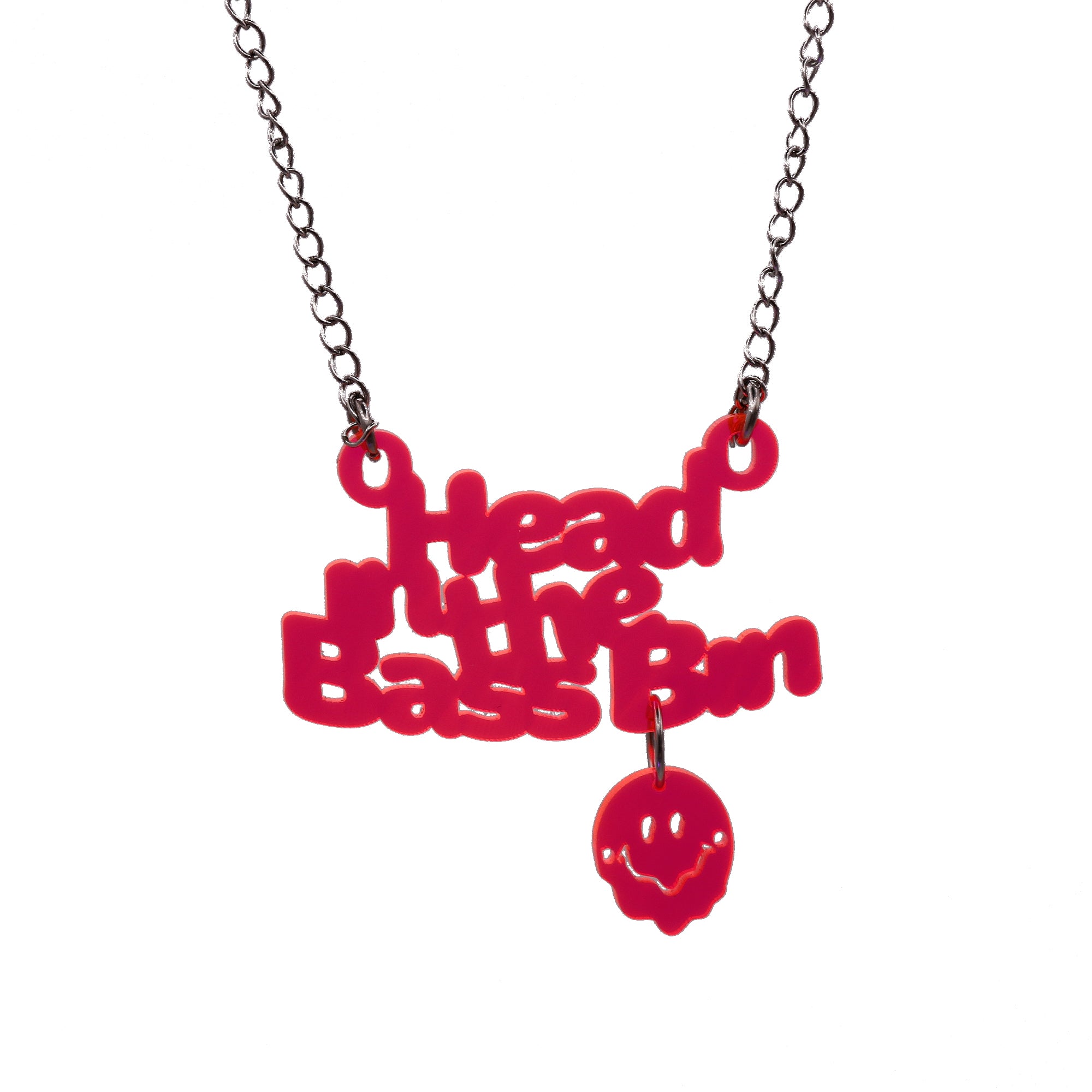 A red acrylic pendant necklace spelling out 'Head in the Bass Bin' with a small matching red smiley face charm hanging below, suspended from a silver-tone chain against a plain white background.