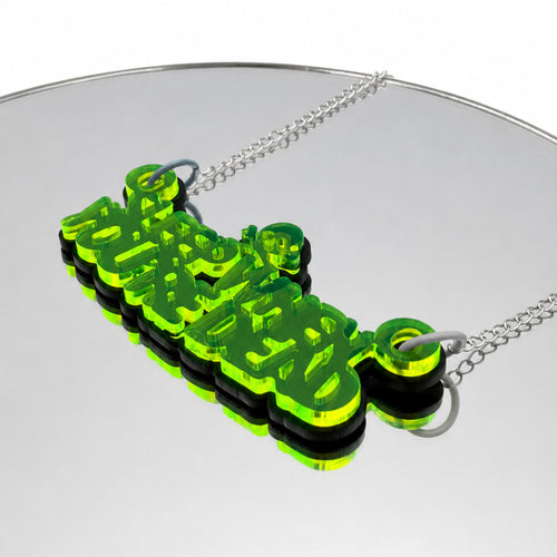 Sleep When You're Dead Green and Black Acrylic Necklace on mirror background